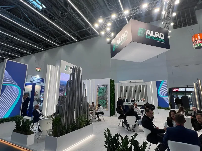 ALRO Extrusion stand (Vimetco Extrusion) at ALUMINIUM 2026 Düsseldorf full of visitors under the suspended cube