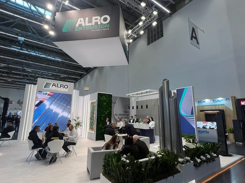 Overview of the ALRO Extrusion stand with suspended cube, LED wall and meeting area